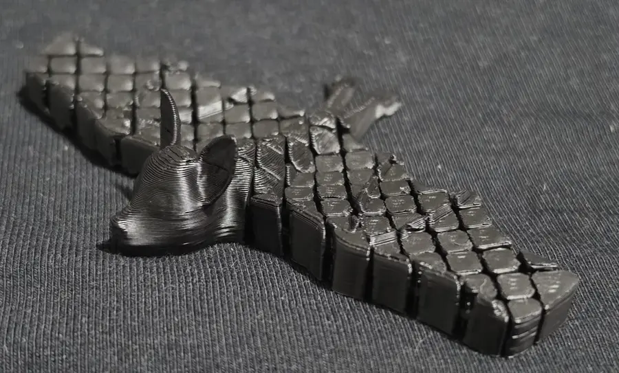 Black articulated bat, wings spread
