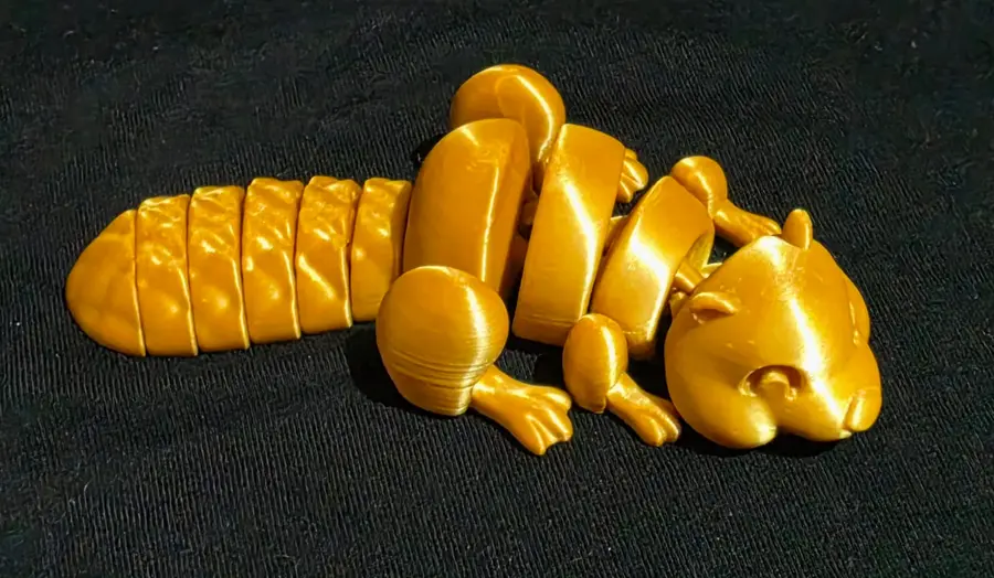 Articulated beaver, gold, curled up