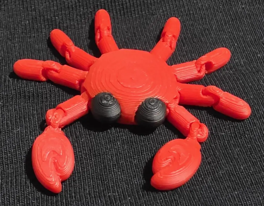 Red articulated crab fidget, front view