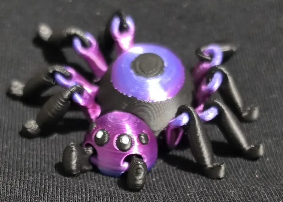 Articulated spider fidget, purple and black, close up